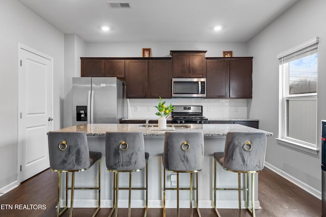 5518 English Holly Way, Knoxville, TN 37914 - kitchen featuring a center island with sink, stainless steel appliances, dark wood-style floors, and dark brown cabinets