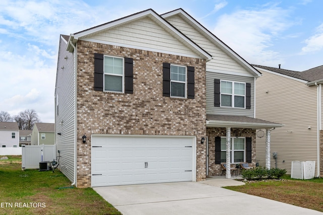 5518 English Holly Way, Knoxville, TN 37914 - craftsman-style home featuring covered porch, driveway, a garage, brick siding, and cooling unit