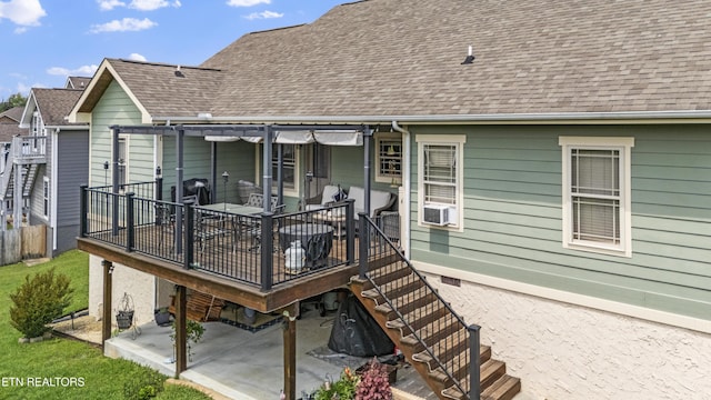 back of property with fence, a patio, and a shingled roof