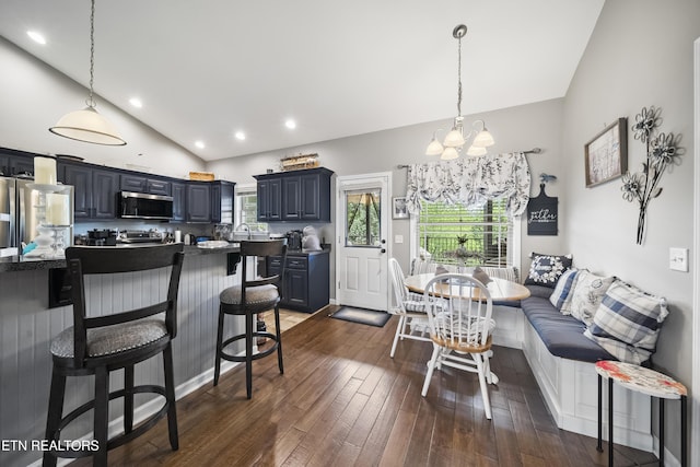living room featuring recessed lighting, an inviting chandelier, vaulted ceiling, and dark wood-type flooring