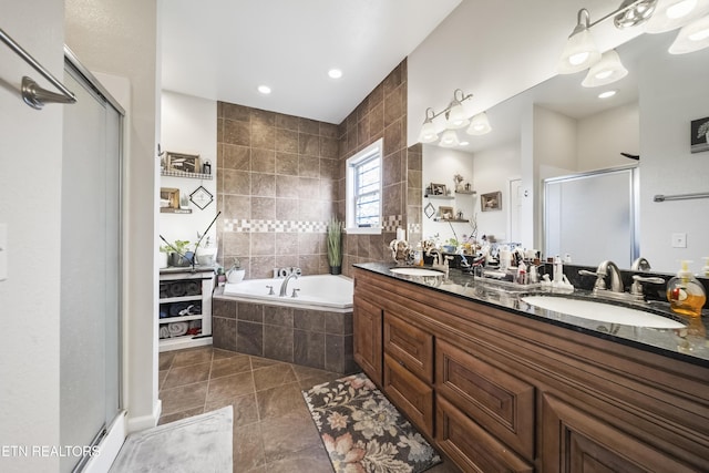 full bath featuring a sink, tile patterned floors, a stall shower, and a bath