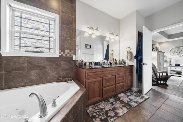 bathroom featuring a whirlpool tub, tile patterned floors, and vanity