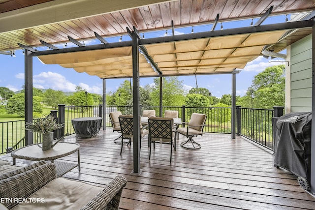wooden deck with outdoor dining area, a pergola, and grilling area