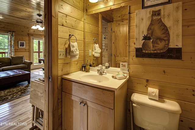 1551 Mountain Dreams Way, Sevierville, TN 37862 - bathroom with vanity, wood walls, wood finished floors, and toilet