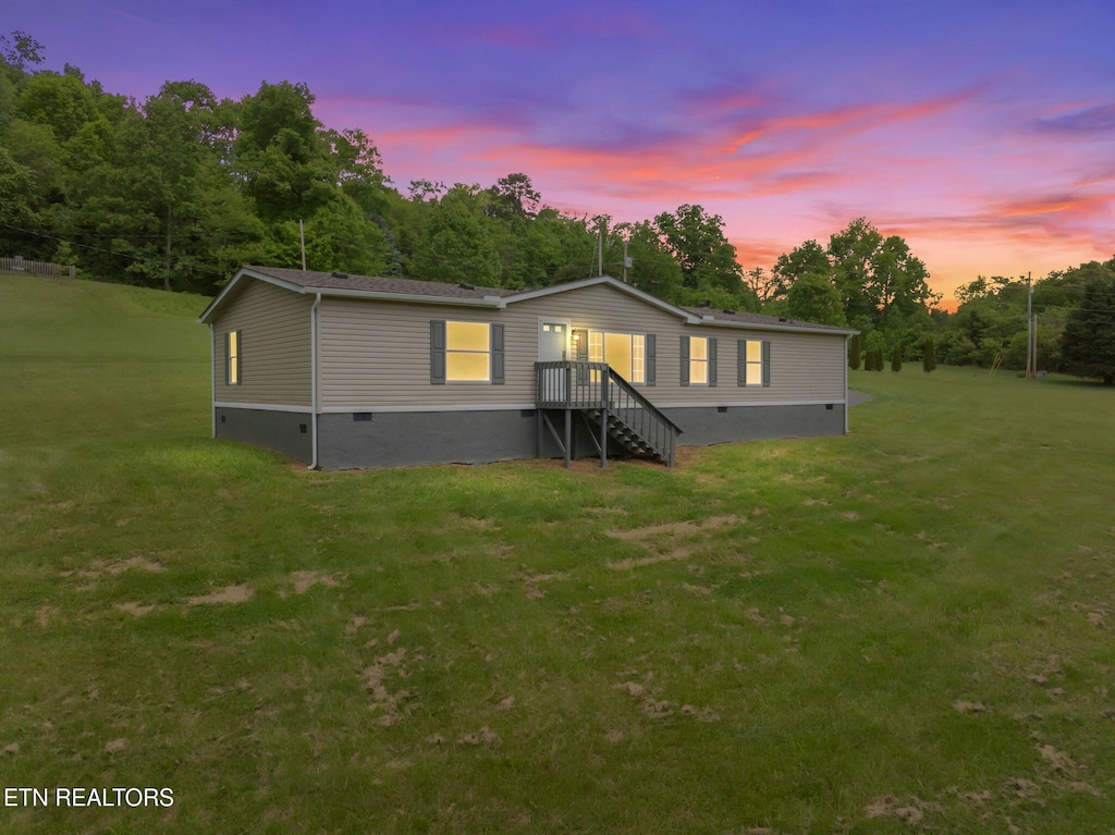 manufactured / mobile home featuring crawl space and a lawn