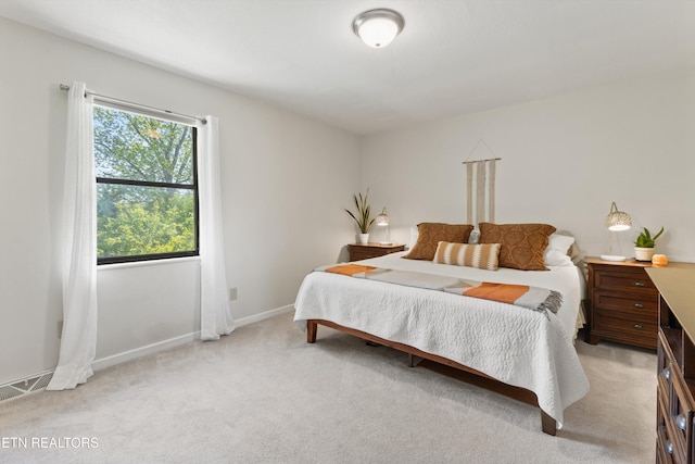bedroom featuring light colored carpet, baseboards, and visible vents