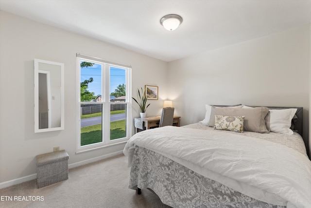 carpeted bedroom featuring baseboards
