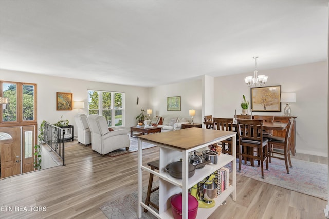 dining room with an inviting chandelier and light wood-style floors