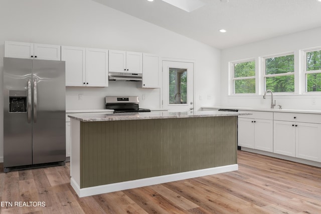 260 Yonside Dr, Sparta, TN 38583 - kitchen featuring a kitchen island, appliances with stainless steel finishes, lofted ceiling, under cabinet range hood, and white cabinetry