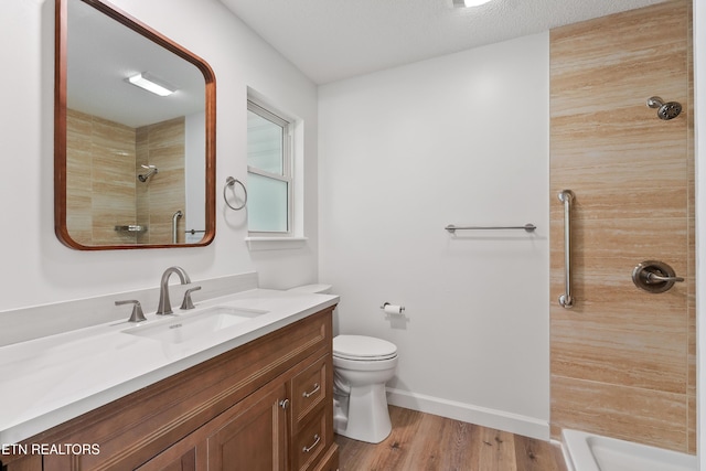 260 Yonside Dr, Sparta, TN 38583 - bathroom with wood finished floors, vanity, baseboards, toilet, and tiled shower