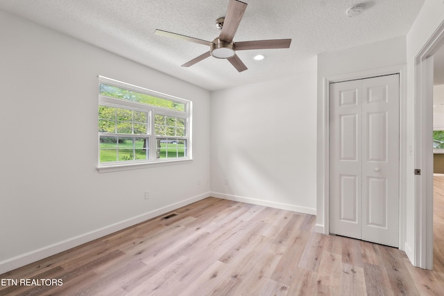 260 Yonside Dr, Sparta, TN 38583 - unfurnished bedroom with a textured ceiling, visible vents, light wood finished floors, and a closet