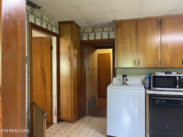 123 Sexton Ln, Clinton, TN 37716 - laundry room featuring washer / dryer, wallpapered walls, and light flooring