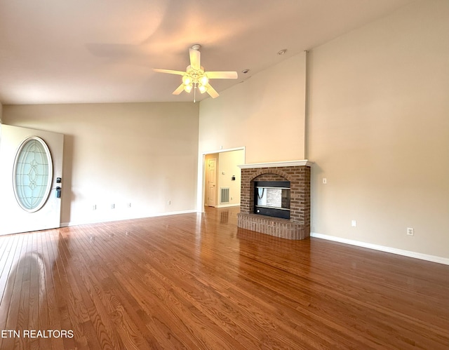 unfurnished living room featuring a ceiling fan, baseboards, high vaulted ceiling, and wood finished floors
