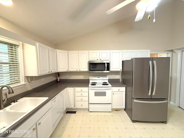 kitchen featuring light floors, stainless steel appliances, white cabinets, and a sink