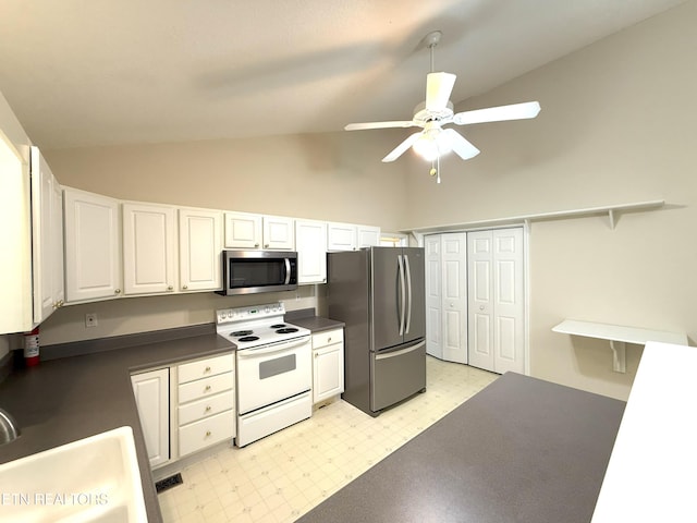 kitchen featuring light floors, ceiling fan, white cabinets, dark countertops, and appliances with stainless steel finishes