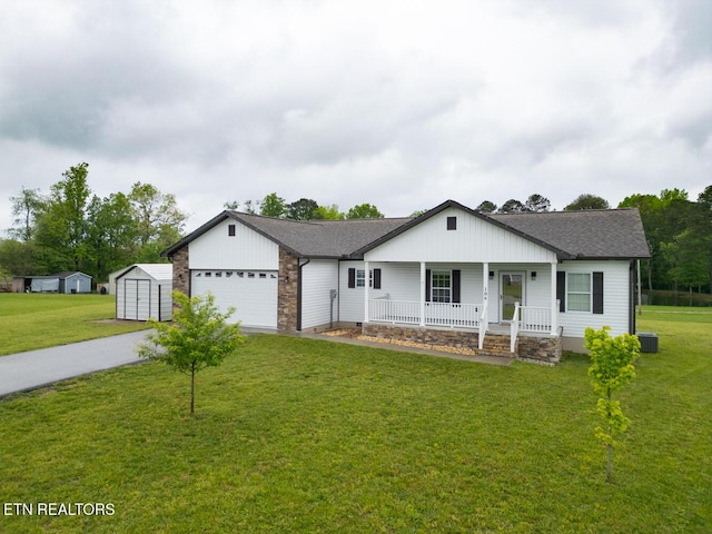 106 Maca Ridge Cir, Clarkrange, TN 38553 - single story home with a porch, a storage shed, concrete driveway, a garage, and a front lawn