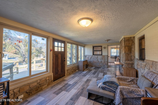 interior space featuring a textured ceiling and wood finished floors