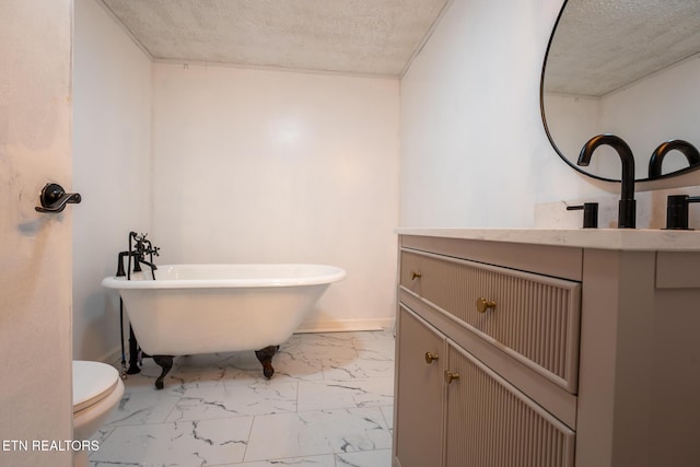 full bathroom with vanity, marble finish floor, toilet, a textured ceiling, and a soaking tub