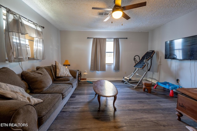 10724 E Emory Rd, Luttrell, TN 37779 - living room with a textured ceiling, wood finished floors, ceiling fan, and baseboards