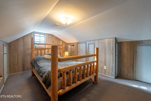 10724 E Emory Rd, Luttrell, TN 37779 - carpeted bedroom with lofted ceiling, wooden walls, and baseboards