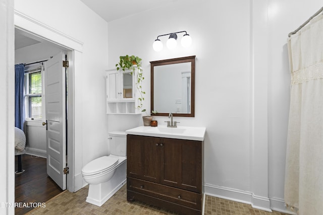 1321 N 4th Ave, Knoxville, TN 37917 - bathroom featuring vanity, baseboards, and toilet