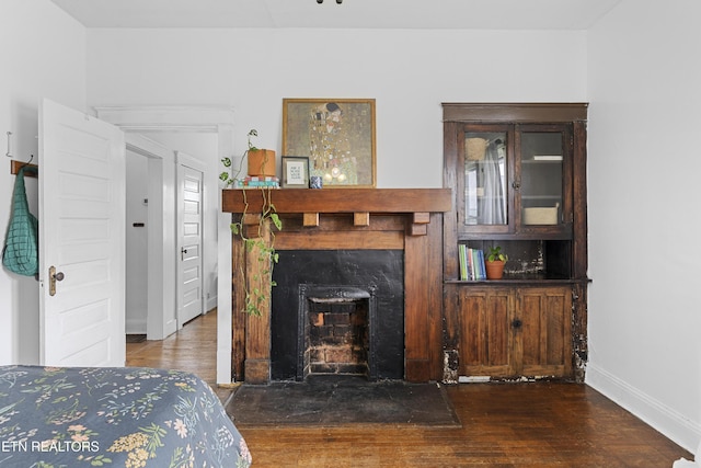 1321 N 4th Ave, Knoxville, TN 37917 - bedroom featuring baseboards, a fireplace, and wood finished floors