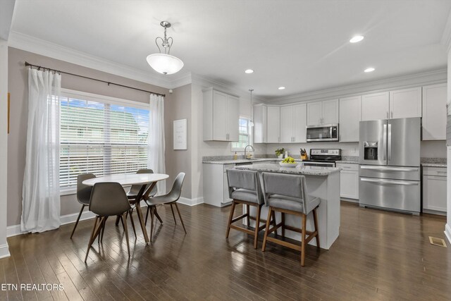 1724 Golden Nugget Ln, Knoxville, TN 37932 - kitchen with appliances with stainless steel finishes, baseboards, crown molding, decorative light fixtures, and white cabinetry