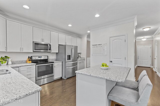 1724 Golden Nugget Ln, Knoxville, TN 37932 - kitchen featuring stainless steel appliances, crown molding, dark wood-style flooring, a kitchen island, and white cabinets