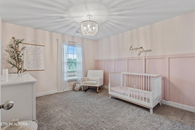 1724 Golden Nugget Ln, Knoxville, TN 37932 - carpeted bedroom with a chandelier, a nursery area, a decorative wall, and wainscoting