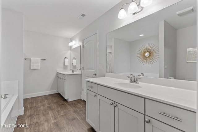 1724 Golden Nugget Ln, Knoxville, TN 37932 - full bathroom with wood finished floors, two vanities, a bath, and baseboards