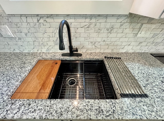 210 Spruce St, Athens, TN 37303 - room details featuring stone countertops, decorative backsplash, and a sink
