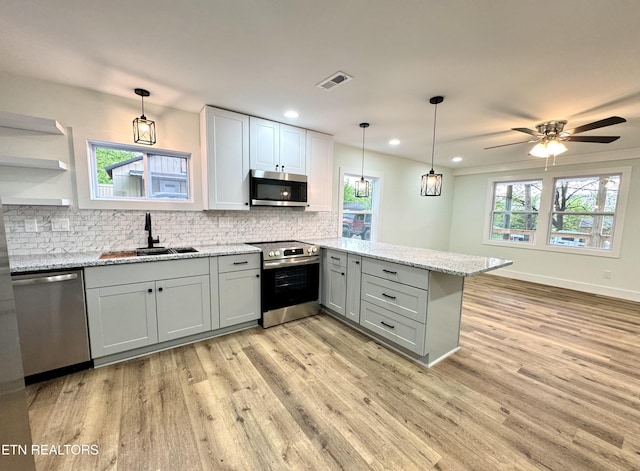 210 Spruce St, Athens, TN 37303 - kitchen with visible vents, appliances with stainless steel finishes, a sink, gray cabinetry, and a peninsula