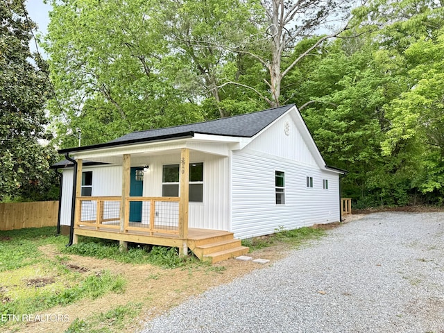 210 Spruce St, Athens, TN 37303 - view of front of house featuring roof with shingles, fence, covered porch, and driveway