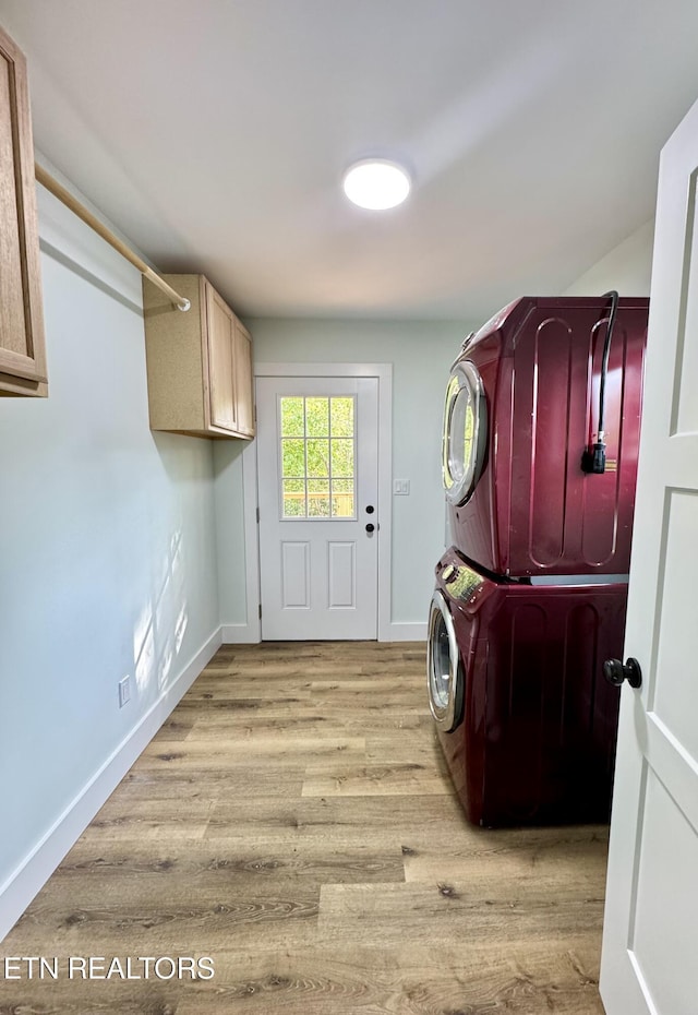 210 Spruce St, Athens, TN 37303 - clothes washing area with cabinet space, baseboards, stacked washer / dryer, and wood finished floors