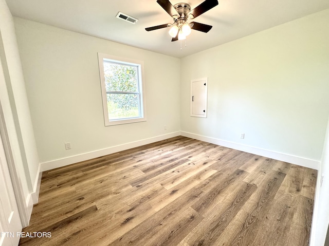 210 Spruce St, Athens, TN 37303 - spare room with visible vents, baseboards, ceiling fan, and wood finished floors