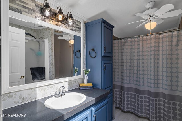 bathroom featuring ceiling fan, curtained shower, and vanity