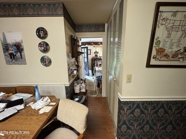 interior space featuring wood finished floors and a wainscoted wall