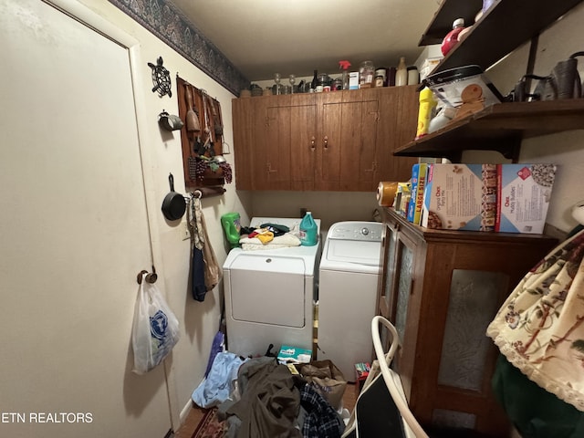 laundry room with cabinet space and washer and clothes dryer