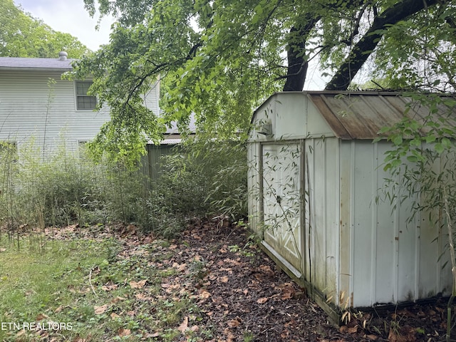 view of shed with fence