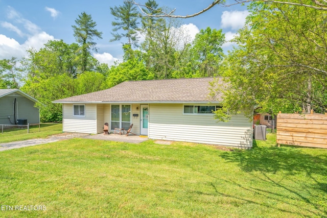 ranch-style home featuring a front lawn, a patio, and fence