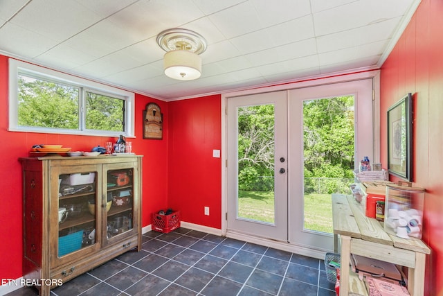 doorway to outside with a wealth of natural light, dark tile patterned floors, french doors, and baseboards