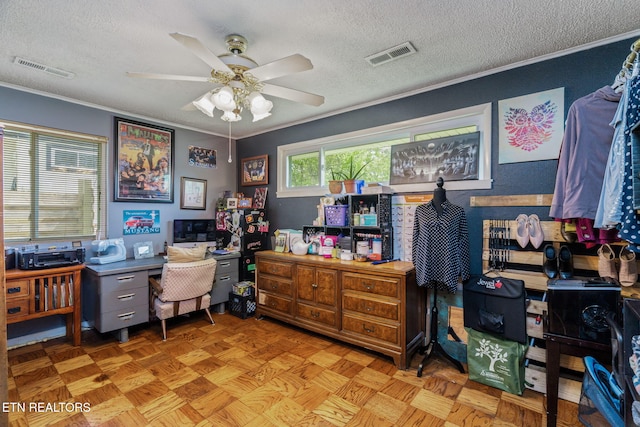 home office featuring ceiling fan, crown molding, visible vents, and a textured ceiling