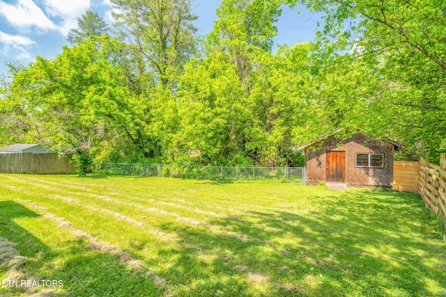 view of yard with an outdoor structure and a fenced backyard