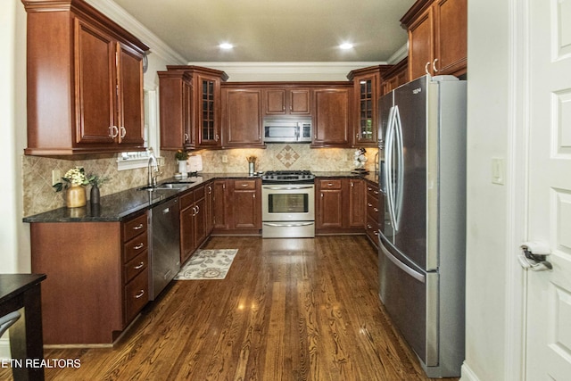 719 Lake Vista Ln Unit 3, Knoxville, TN 37934 - kitchen featuring appliances with stainless steel finishes, a sink, dark wood finished floors, dark stone countertops, and glass insert cabinets