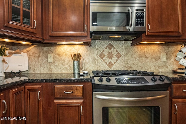 719 Lake Vista Ln Unit 3, Knoxville, TN 37934 - kitchen with appliances with stainless steel finishes, decorative backsplash, and dark stone countertops