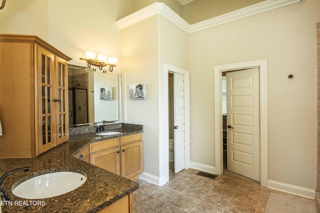 719 Lake Vista Ln Unit 3, Knoxville, TN 37934 - bathroom featuring crown molding, a notable chandelier, vanity, baseboards, and a shower stall