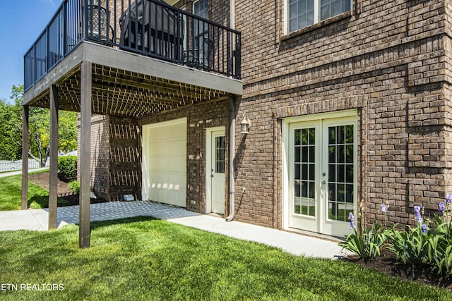 719 Lake Vista Ln Unit 3, Knoxville, TN 37934 - doorway to property featuring brick siding, a garage, a lawn, and french doors