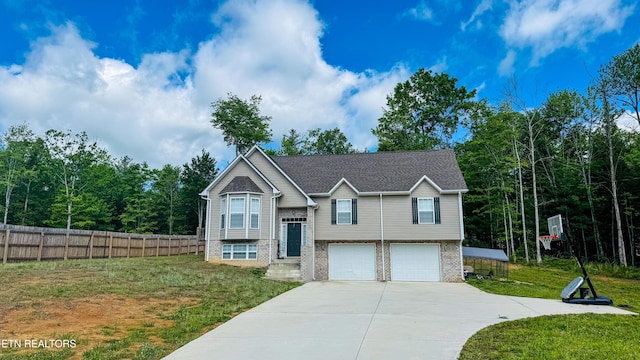 344 Kayla Ln, Oneida, TN 37841 - raised ranch with an attached garage, fence, concrete driveway, a front lawn, and brick siding
