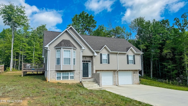 344 Kayla Ln, Oneida, TN 37841 - bi-level home featuring a garage, a wooden deck, concrete driveway, a front lawn, and brick siding