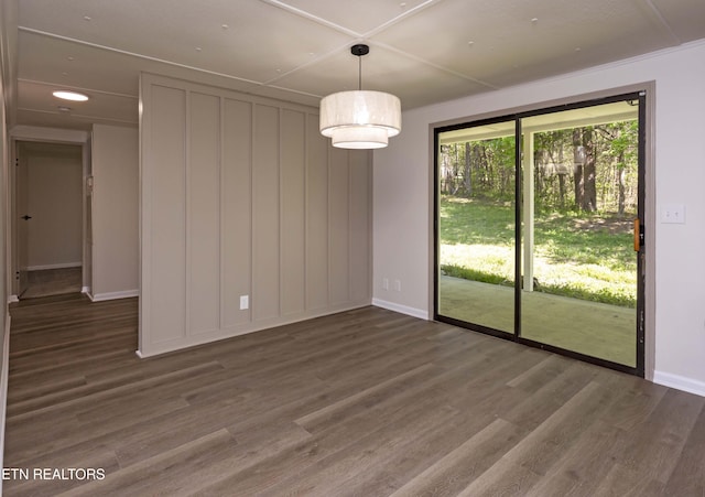 unfurnished dining area featuring baseboards and wood finished floors